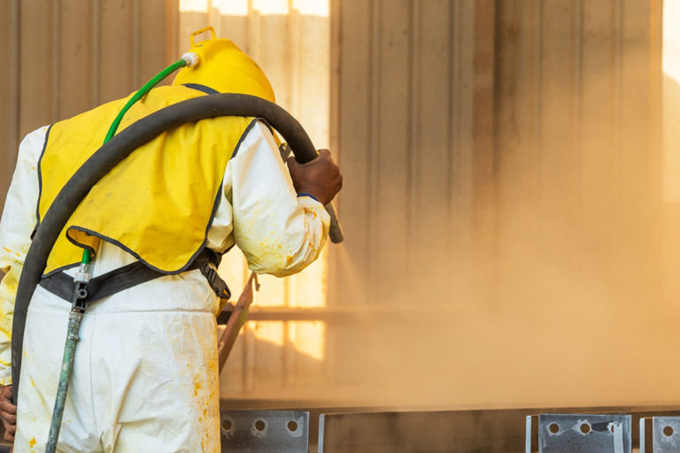 Technician from a perth powdercoating services company doing a sand blasting process