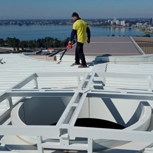 Man from Precision Powdercoating performing a Prime & Corrosion Protection on a roof