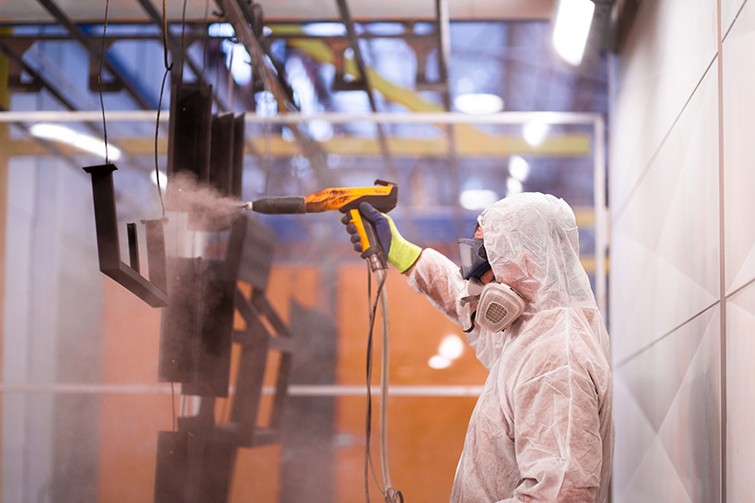 pc22 Skilled technician from a powdercoating perth company powdercoatng a piece of metal