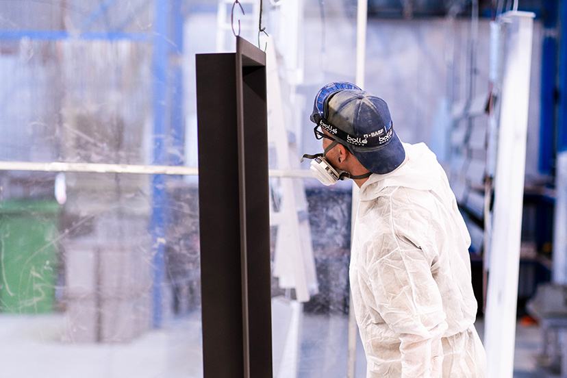 pc4 Technician from a powdercoating perth company looking at a piece of metal